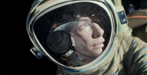 Sandra Bullock looking off into space in Alfonso Cuarón's GRAVITY. Photo courtesy of Warner Brothers.
